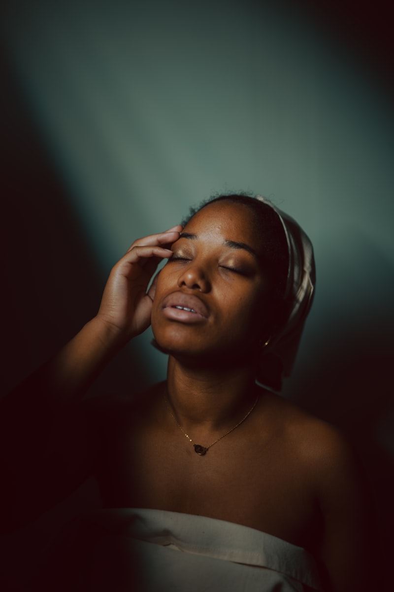 A person wearing headphones with eyes closed, absorbed in music
